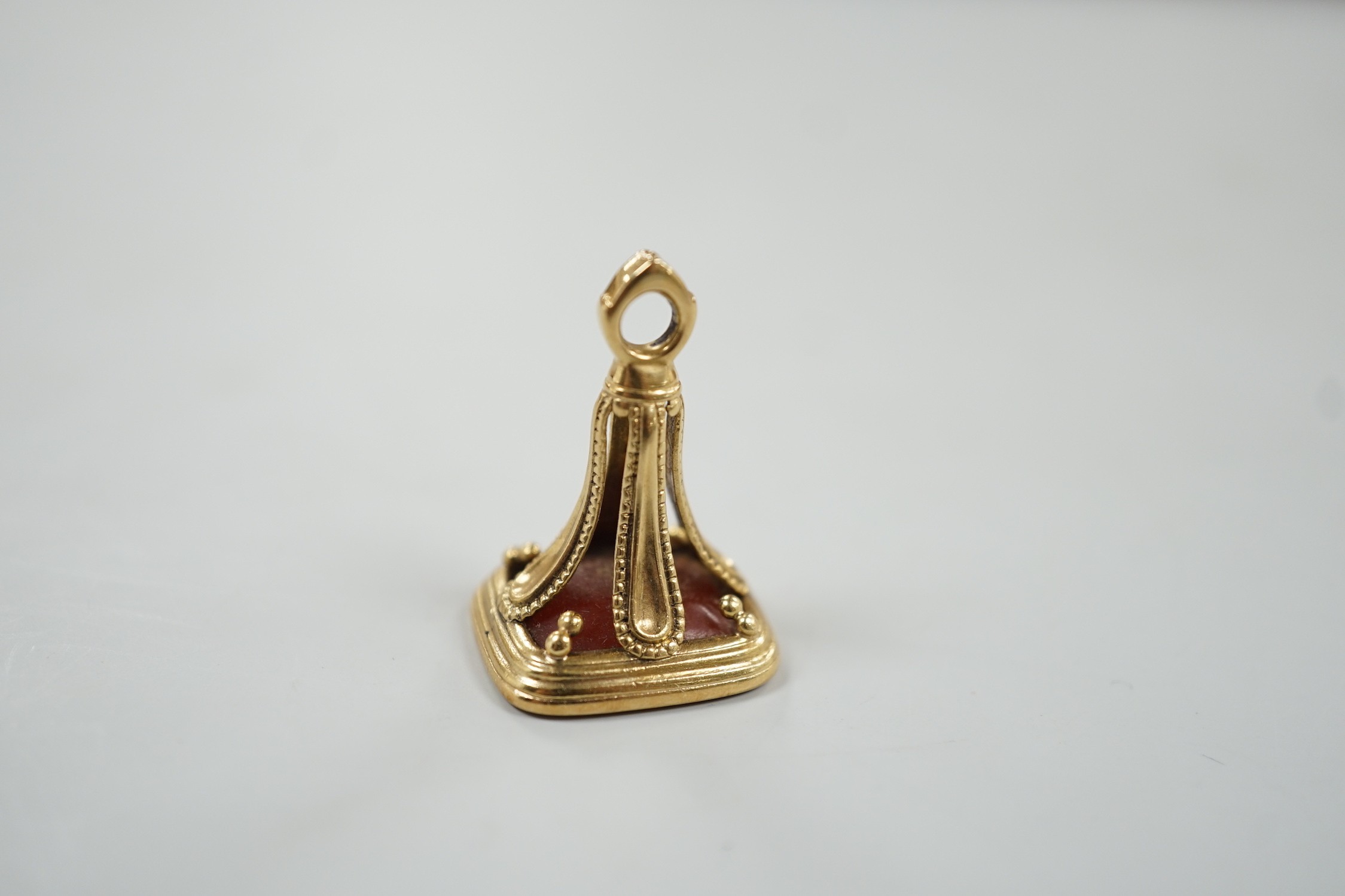 An early 19th century yellow metal overlaid and carnelian set fob seal, the matrix carved with armorial, 29mm.